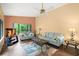 Comfortable living room with plush seating, wood-look tile floor, ceiling fan, and large window with peaceful view at 4637 Willow Wood Cir # 44, Sarasota, FL 34241