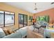 Bright living room featuring stylish furniture, wood-look tile floor, neutral walls and views of a private courtyard at 4637 Willow Wood Cir # 44, Sarasota, FL 34241