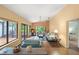 Bright living room with high ceilings, comfortable seating, and sliding doors to the outside at 4637 Willow Wood Cir # 44, Sarasota, FL 34241
