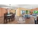 Open-concept living space with dining area, wood floors, and ample natural light at 4637 Willow Wood Cir # 44, Sarasota, FL 34241