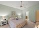 Spacious main bedroom featuring king bed, ensuite bathroom, nightstands, peaceful artwork and neutral walls at 4637 Willow Wood Cir # 44, Sarasota, FL 34241