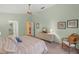 Large main bedroom featuring ensuite bathroom, ceiling fan, dresser, neutral carpeting and peaceful backyard views at 4637 Willow Wood Cir # 44, Sarasota, FL 34241