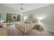 Relaxing main bedroom features soft green walls, king bed, ceiling fan and peaceful views of a lush garden at 4637 Willow Wood Cir # 44, Sarasota, FL 34241