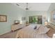 Comfortable main bedroom with large window, king bed, dresser and ceiling fan with neutral walls and carpeting at 4637 Willow Wood Cir # 44, Sarasota, FL 34241