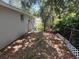 A view of the backyard featuring a chainlink fence, side of house and small window at 4740 Garcia Ave, Sarasota, FL 34233