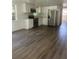 Bright kitchen features white cabinets, stainless steel appliances, and wood-look flooring at 4740 Garcia Ave, Sarasota, FL 34233
