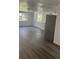 Open-concept living area features wood-look flooring, bright windows, and neutral paint at 4740 Garcia Ave, Sarasota, FL 34233