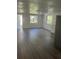 Open-concept living area features wood-look flooring, bright windows, and neutral paint at 4740 Garcia Ave, Sarasota, FL 34233