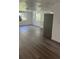 Open-concept living area features wood-look flooring, bright windows, and neutral paint at 4740 Garcia Ave, Sarasota, FL 34233