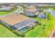 An aerial view of a home featuring a screened in pool, immaculate landscaping, and view of the lake and neighborhood at 4925 Coastal Days Ln, Bradenton, FL 34211