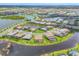 Aerial view of homes in a large community with multiple retention ponds and well manicured lawns at 4925 Coastal Days Ln, Bradenton, FL 34211