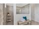 Tiled walk-in shower with glass partition and built-in showerhead, plus bench seating with towels at 4925 Coastal Days Ln, Bradenton, FL 34211