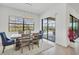 Bright dining room boasts modern lighting and dining table with seating, and sliding glass doors to outdoor pool area at 4925 Coastal Days Ln, Bradenton, FL 34211