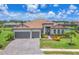 Beautiful single-Gathering home featuring a tile roof, three-car garage, and well-manicured landscaping at 4925 Coastal Days Ln, Bradenton, FL 34211
