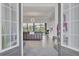 Open concept foyer leading into a well-lit living area, showcasing a stylish chandelier and elegant décor at 4925 Coastal Days Ln, Bradenton, FL 34211
