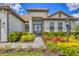 Charming home entrance with well-manicured landscaping and a decorative front door, creating a welcoming curb appeal at 4925 Coastal Days Ln, Bradenton, FL 34211