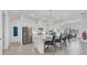 Kitchen featuring stainless steel appliances, a breakfast bar with modern pendant lighting, and white cabinets at 4925 Coastal Days Ln, Bradenton, FL 34211