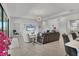 Comfortable living area featuring sleek tile flooring, and an entertainment center with a large screen television at 4925 Coastal Days Ln, Bradenton, FL 34211