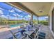 A beautiful screened patio and dining table featuring a dining table for six overlooking a pool and beautiful scenery at 4925 Coastal Days Ln, Bradenton, FL 34211