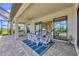 Screened patio featuring a dining table for six, beautiful blue rug, sliding door into the living room, and ceiling fan at 4925 Coastal Days Ln, Bradenton, FL 34211