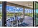 Screened patio dining area featuring a dining table for six overlooking a sparkling pool and lush landscaping at 4925 Coastal Days Ln, Bradenton, FL 34211