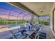 Inviting screened-in patio featuring an outdoor dining area, overlooking the pool and lush backyard at 4925 Coastal Days Ln, Bradenton, FL 34211