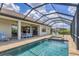 Sparkling swimming pool with jacuzzi, beautiful stone patio, and large covered patio with dining area and lounge chairs at 4925 Coastal Days Ln, Bradenton, FL 34211