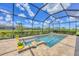 Relaxing screened-in pool and spa area surrounded by lush landscaping, perfect for outdoor enjoyment at 4925 Coastal Days Ln, Bradenton, FL 34211