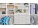 Organized walk-in closet with shelves, drawers, and hanging rods for optimal storage and organization at 4925 Coastal Days Ln, Bradenton, FL 34211