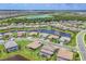 Beautiful aerial view of home in a lakeside community with well-manicured lawns and mature trees at 4925 Coastal Days Ln, Lakewood Ranch, FL 34211