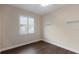The bedroom features wood floors and white trim with natural light from the window at 4998 Cedar Oak Way, Sarasota, FL 34233