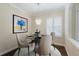 Bright dining area with a modern chandelier, round table, and stylish decor at 4998 Cedar Oak Way, Sarasota, FL 34233
