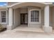 Inviting front entrance with double doors, white columns and tiled entryway at 4998 Cedar Oak Way, Sarasota, FL 34233