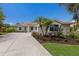 Beautiful home featuring a tile roof, lush landscaping, and an inviting driveway and walkway at 4998 Cedar Oak Way, Sarasota, FL 34233