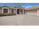 Close-up view of the front entrance and two-car garage of the home featuring a large driveway at 4998 Cedar Oak Way, Sarasota, FL 34233