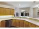 Kitchen boasting stainless steel dishwasher and view to screened-in lanai and pool at 4998 Cedar Oak Way, Sarasota, FL 34233