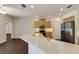 Well-lit kitchen featuring a breakfast bar, stainless steel appliances, and wood cabinets at 4998 Cedar Oak Way, Sarasota, FL 34233