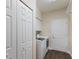 Bright laundry room with ample storage space, a modern washer and dryer, and a closet at 4998 Cedar Oak Way, Sarasota, FL 34233