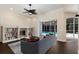 Comfortable living room with built-in bookshelves, a ceiling fan, and a view of the outdoor pool at 4998 Cedar Oak Way, Sarasota, FL 34233