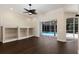 Bright living space with built-in shelves and a sliding glass door leading to the pool area at 4998 Cedar Oak Way, Sarasota, FL 34233