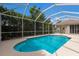 An inviting backyard pool area with an enclosed screen for outdoor enjoyment at 4998 Cedar Oak Way, Sarasota, FL 34233