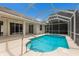 A beautiful pool and patio area encased in a large screened enclosure with ample sunshine at 4998 Cedar Oak Way, Sarasota, FL 34233