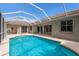 Enclosed pool area features a sparkling pool, tile roof, and covered patio at 4998 Cedar Oak Way, Sarasota, FL 34233