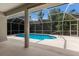 Backyard pool with screened enclosure, with sunny skies at 4998 Cedar Oak Way, Sarasota, FL 34233