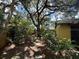 Lush backyard with mature trees and shrubbery at 5032 81St Avenue E Ter, Sarasota, FL 34243