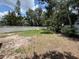 Flat, grassed backyard with a white privacy fence on a sunny day at 5032 81St Avenue E Ter, Sarasota, FL 34243