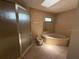 Bathroom with a walk-in shower, bidet, and a corner soaking tub at 5032 81St Avenue E Ter, Sarasota, FL 34243