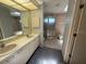 Bathroom featuring double sinks, walk-in shower, and tile floors at 5032 81St Avenue E Ter, Sarasota, FL 34243