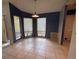 Cozy dining area with tile floors, natural light, and a modern pendant light fixture at 5032 81St Avenue E Ter, Sarasota, FL 34243