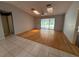 Open concept living room with hardwood floors, vaulted ceilings, and sliding glass doors to the backyard at 5032 81St Avenue E Ter, Sarasota, FL 34243
